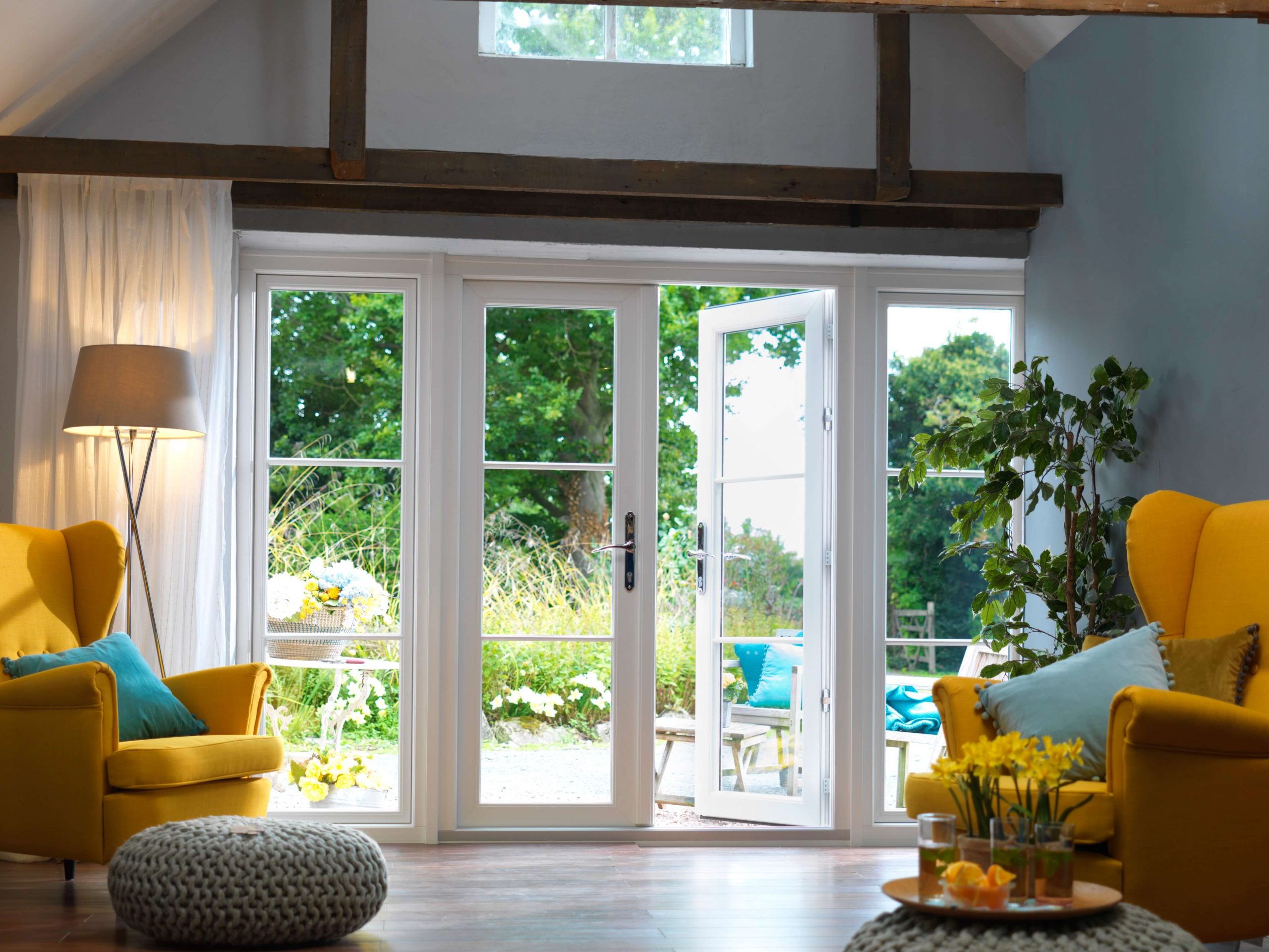 Classic white french doors opening onto a garden , bringing light and space into the home