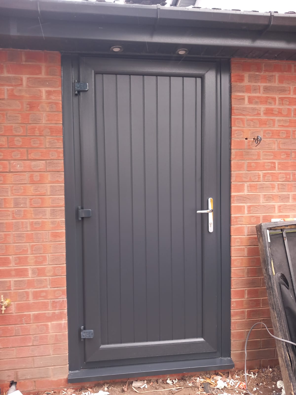 Installed composite entrance door in a modern grey finish
