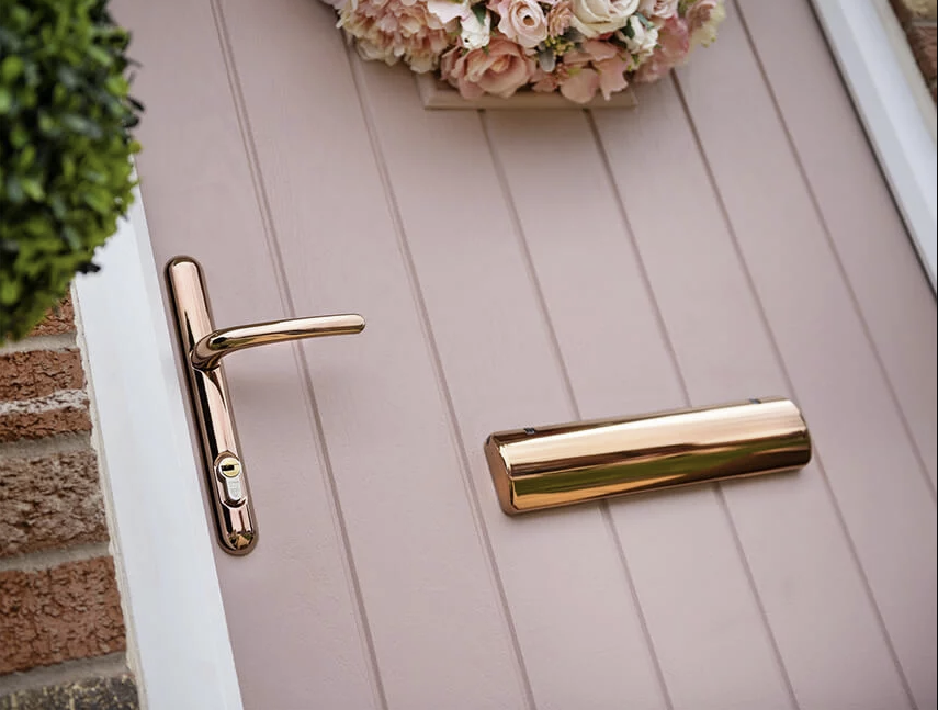 Pink entrance door with rose-gold furniture