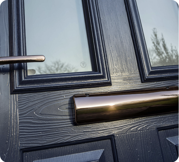 Black composite door with rose-gold furniture